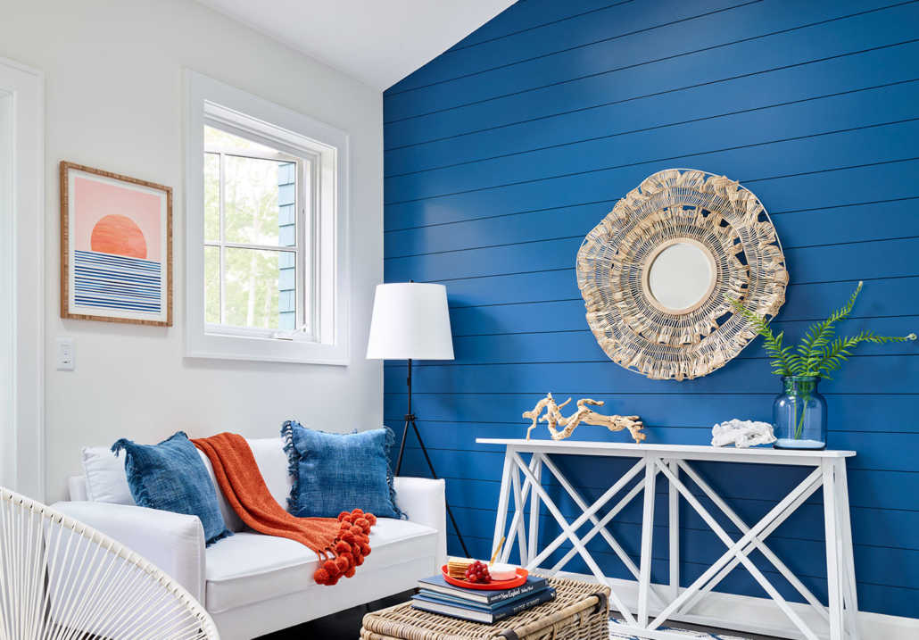 Room with neutral paint colors and bold accent patterns.