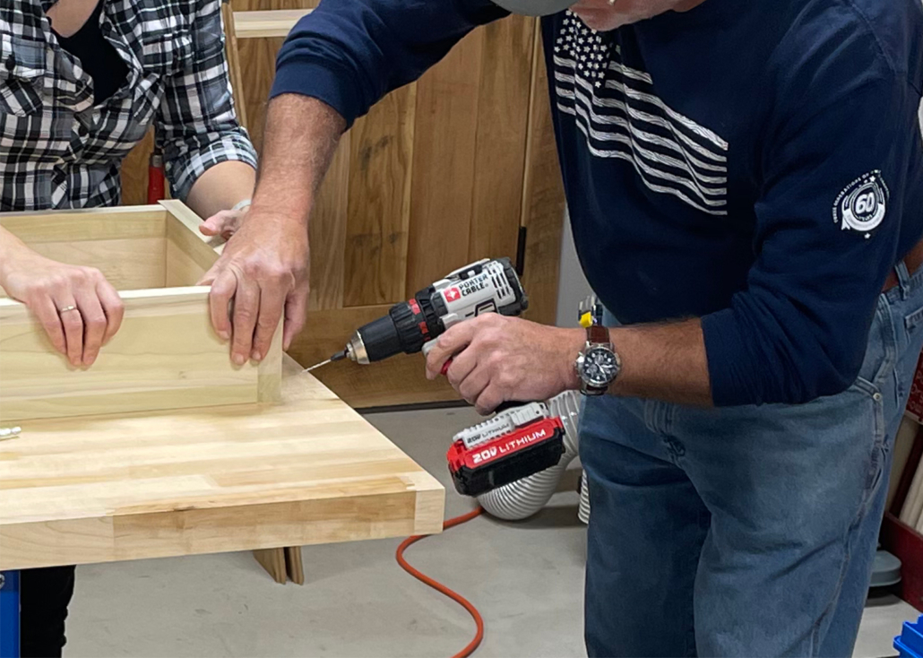 Power drill being used by a woodworker.