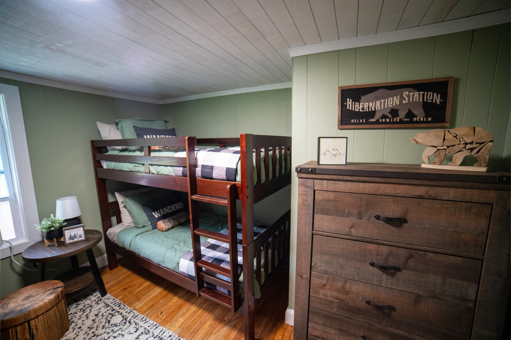 A hunting cabin with bunk beds in the bedroom. 