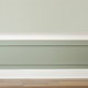 Baseboard moulding covering the gap between the flooring and the wall.