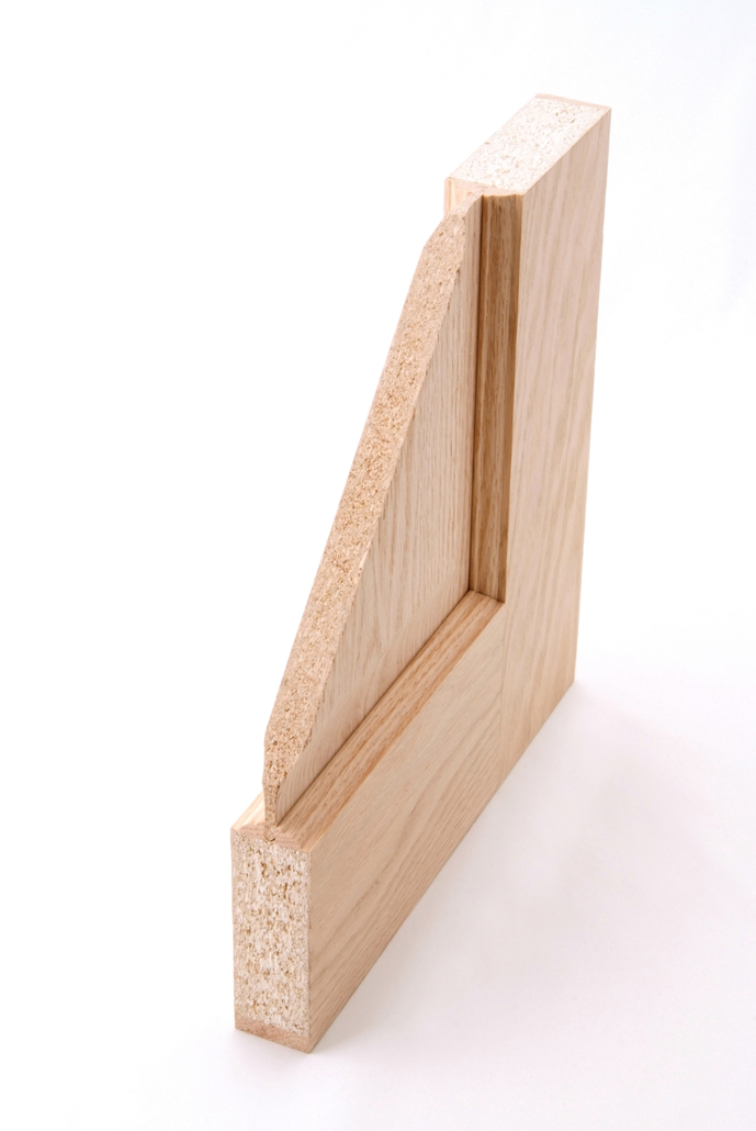 A wood veneer door cut open to show the difference between the face material and core material. 