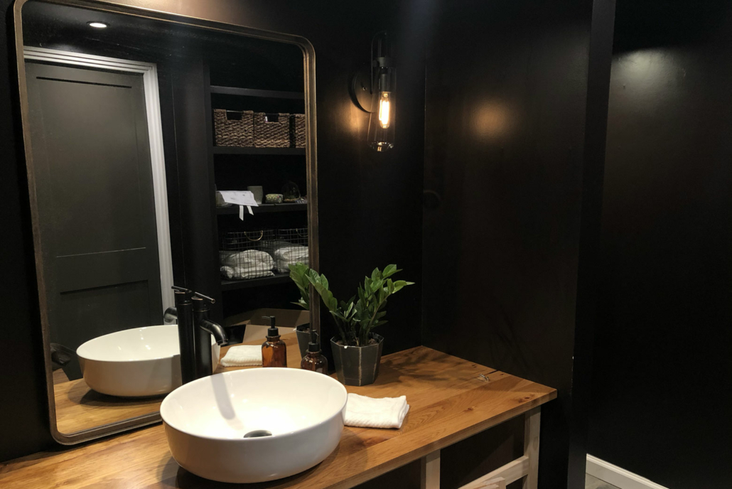 A bathroom renovation featuring plank style wooden countertops.
