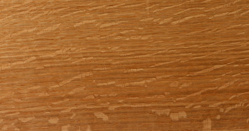 The grain pattern of quarter sawn white oak flooring. 